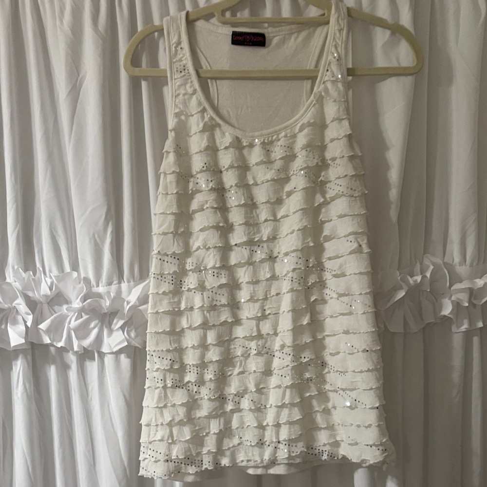 Cream Ruffled Eyelet Tank Top with silver sequin all over the front of it.